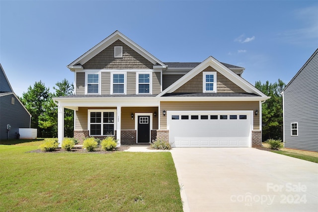 craftsman inspired home featuring a garage, a porch, and a front yard