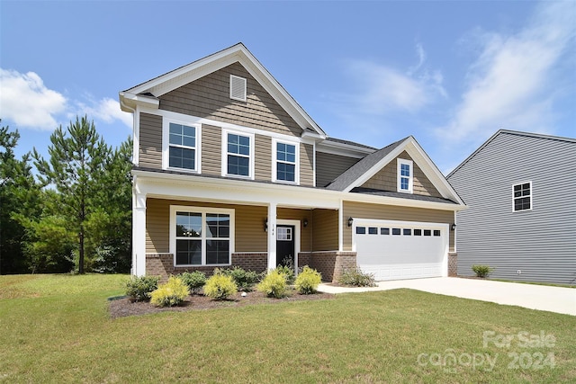 craftsman house with a garage, a front lawn, and a porch