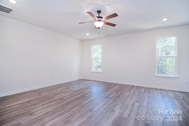 empty room featuring hardwood / wood-style flooring and a wealth of natural light