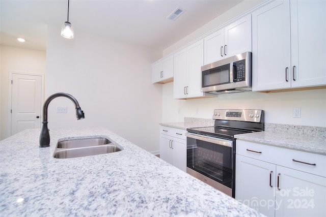 kitchen with stainless steel appliances, decorative light fixtures, sink, light stone counters, and white cabinets