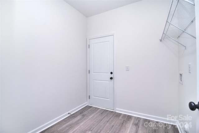 clothes washing area featuring washer hookup and hardwood / wood-style floors