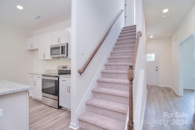 staircase featuring hardwood / wood-style flooring