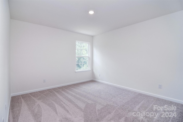 unfurnished room with carpet flooring