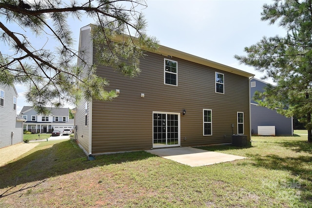 rear view of property with central air condition unit, a patio, and a lawn