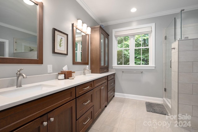 bathroom featuring tile patterned flooring, vanity, a shower with door, and ornamental molding