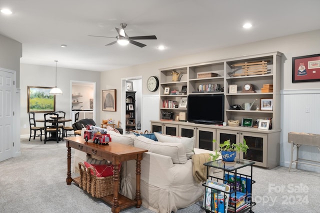 living room with ceiling fan and light colored carpet