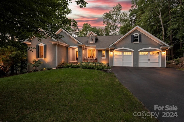 view of front of home featuring a lawn and a garage