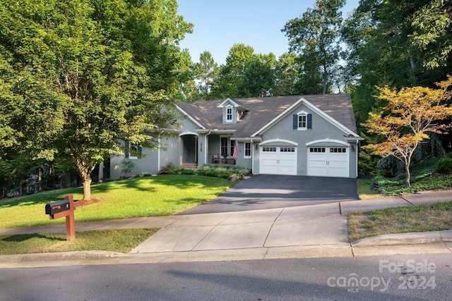 view of front of house featuring a garage and a front yard