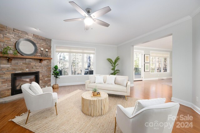 living room with hardwood / wood-style floors, a healthy amount of sunlight, and crown molding