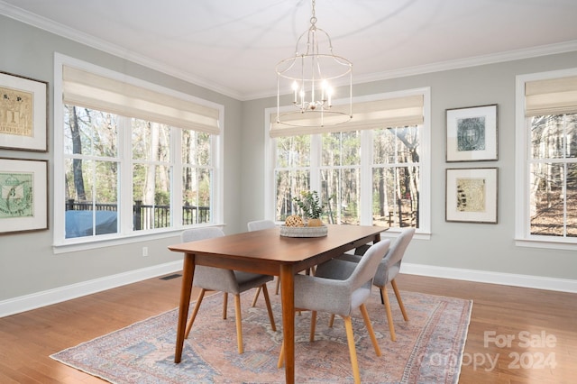 6 Larue Ct, Biltmore Lake, NC 28715 - dining space featuring wood finished floors, a chandelier, healthy amount of natural light, and crown molding