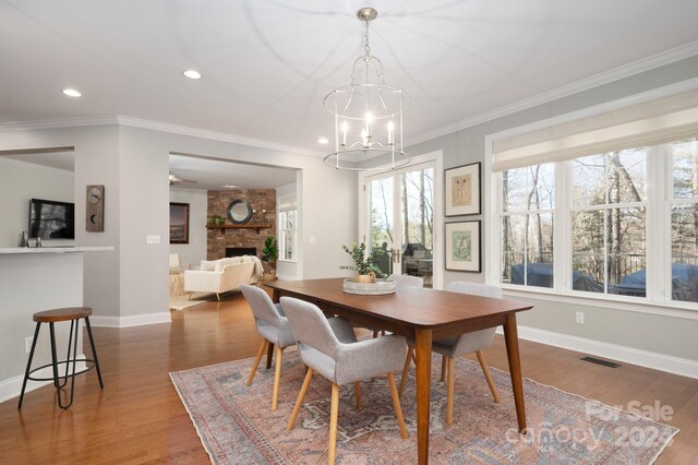 6 Larue Ct, Biltmore Lake, NC 28715 - dining room featuring a chandelier, a large fireplace, wood finished floors, recessed lighting, and crown molding