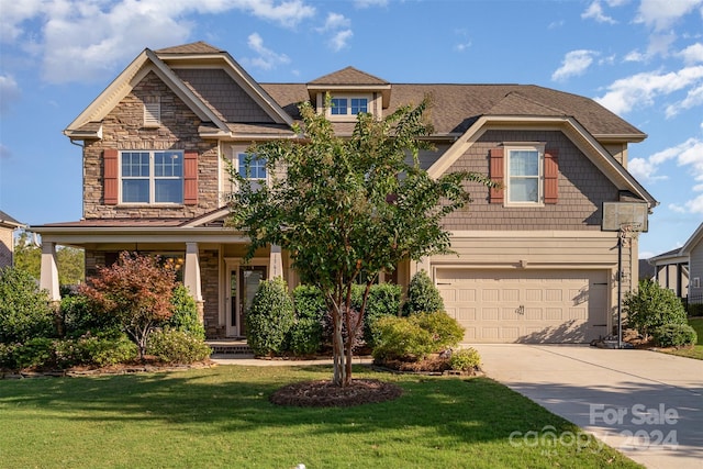 craftsman house featuring a garage and a front lawn