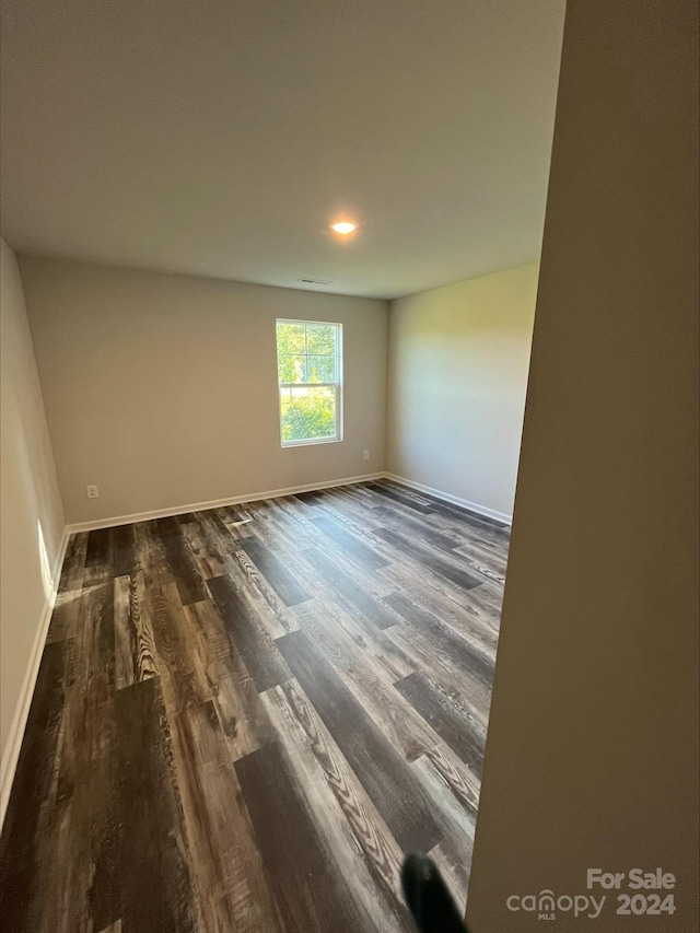 unfurnished room with hardwood / wood-style floors