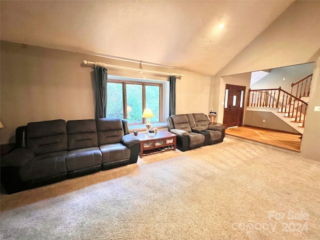 carpeted living room with vaulted ceiling