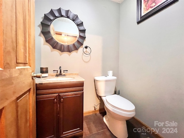 bathroom featuring vanity, toilet, and tile patterned floors