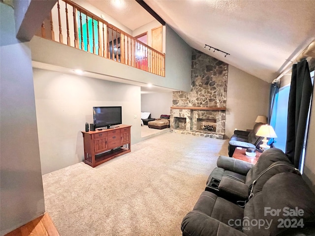 living room with a fireplace, a textured ceiling, high vaulted ceiling, and carpet