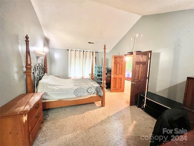 carpeted bedroom with lofted ceiling