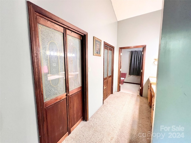 hallway featuring light colored carpet