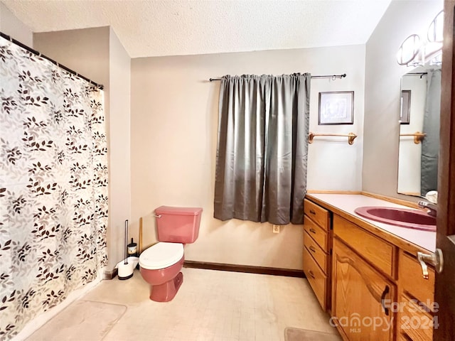 bathroom featuring vanity, toilet, a shower with curtain, and a textured ceiling