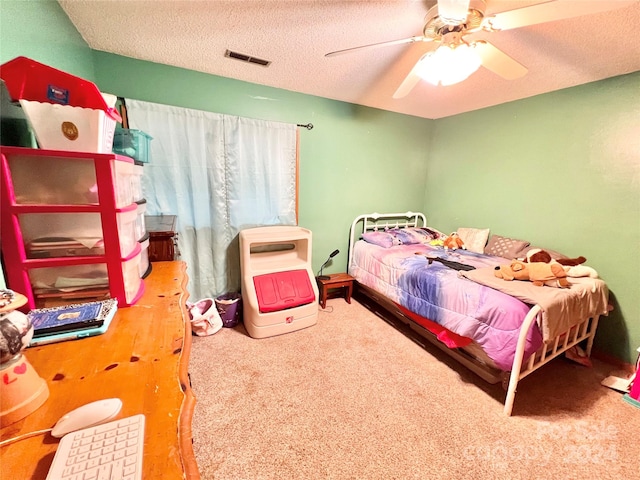 carpeted bedroom with a textured ceiling and ceiling fan