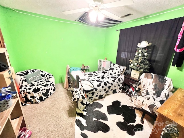 bedroom with a textured ceiling, ceiling fan, and carpet