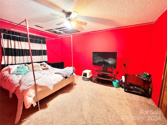 bedroom with a textured ceiling, ceiling fan, and carpet