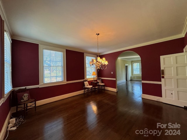 unfurnished dining area with ornamental molding, dark wood-type flooring, and an inviting chandelier