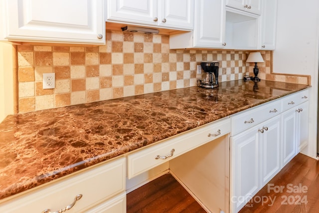 kitchen with decorative backsplash, dark hardwood / wood-style flooring, and white cabinetry