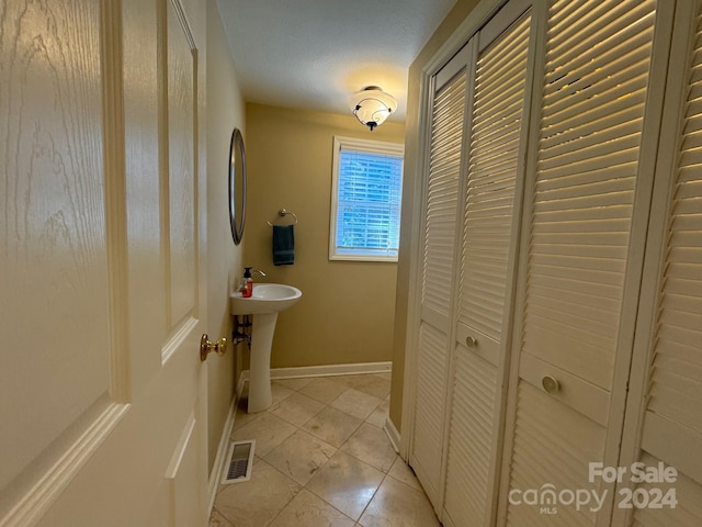 bathroom featuring tile patterned flooring and sink