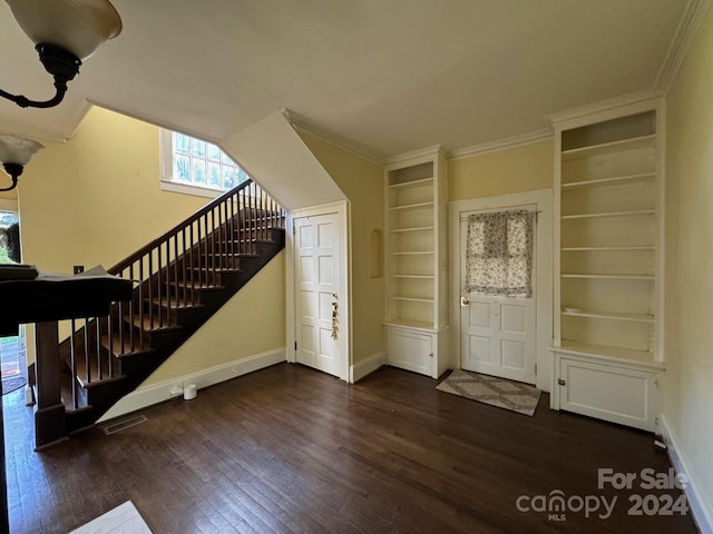 foyer featuring dark hardwood / wood-style floors and crown molding