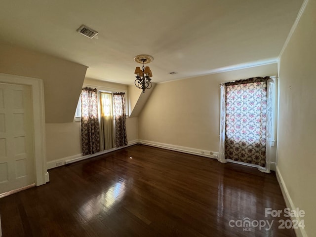 spare room featuring dark hardwood / wood-style flooring and ornamental molding