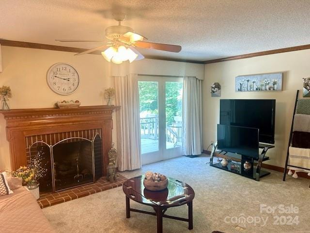 carpeted living room with a fireplace, a textured ceiling, ceiling fan, and crown molding