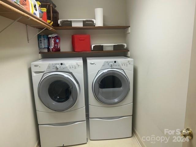 clothes washing area with washing machine and dryer