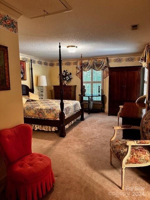 bedroom with light carpet and a textured ceiling