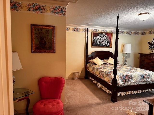 bedroom featuring carpet, a textured ceiling, and ornamental molding