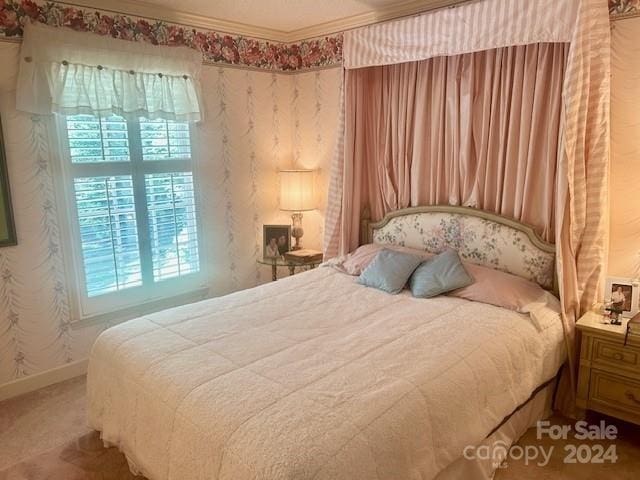 carpeted bedroom with ornamental molding