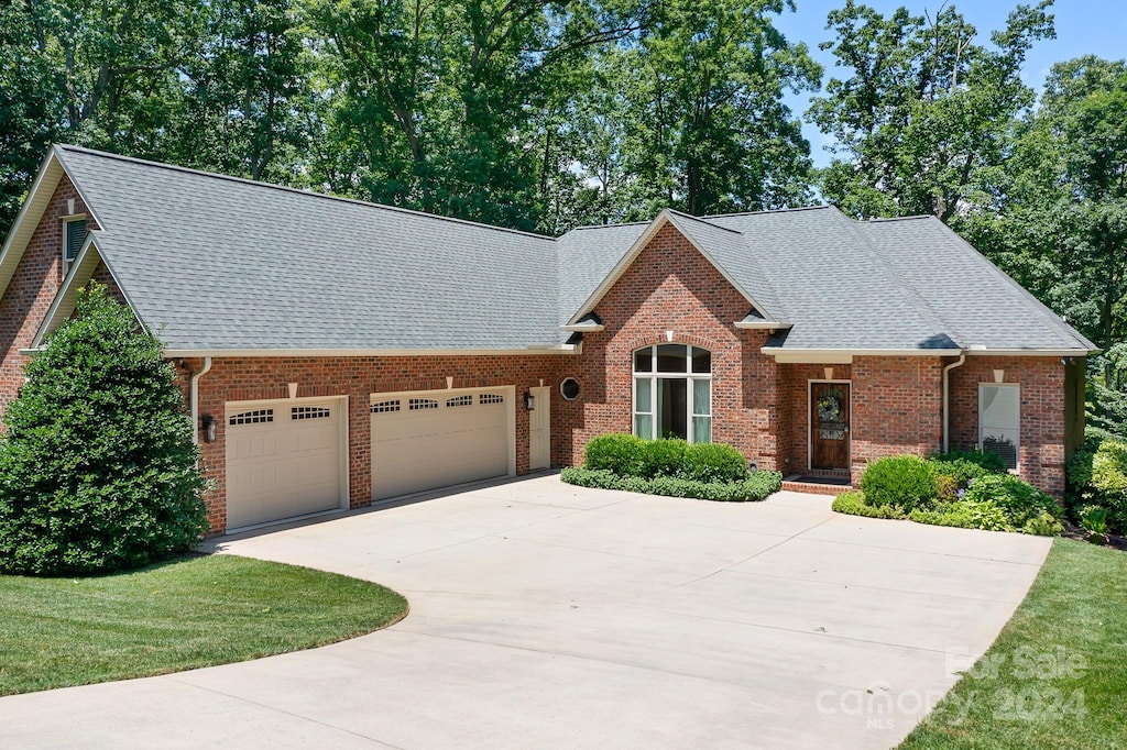 front of property featuring a front yard and a garage