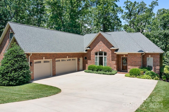 front of property featuring a front yard and a garage