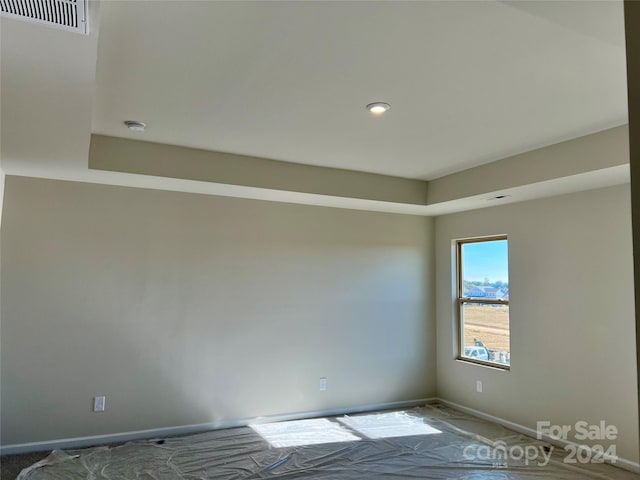 empty room with a tray ceiling