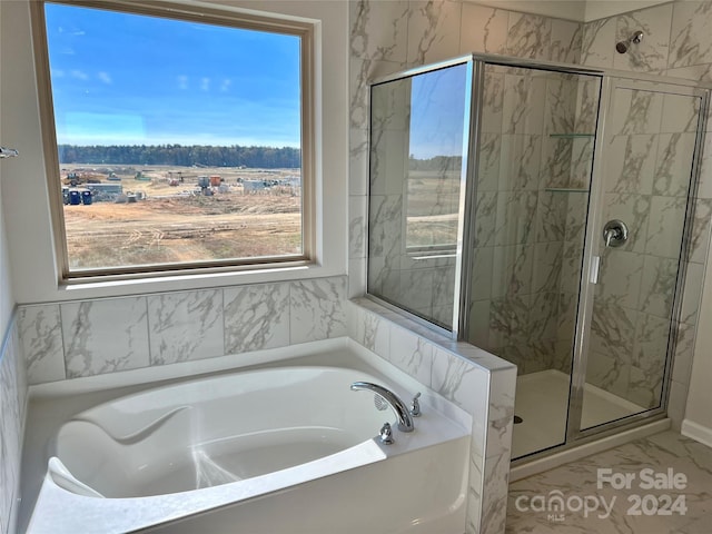 bathroom featuring tile patterned flooring and separate shower and tub