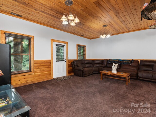 carpeted living room with wood ceiling, plenty of natural light, and a chandelier