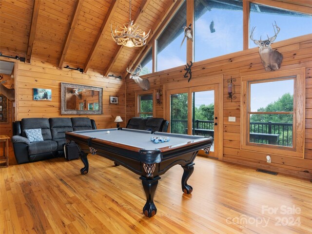 game room featuring a wealth of natural light, pool table, light hardwood / wood-style flooring, and beam ceiling