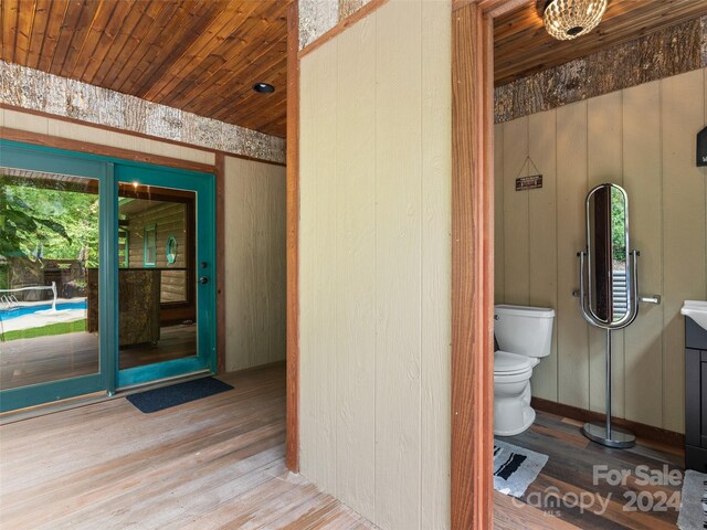 bathroom featuring toilet, wooden ceiling, hardwood / wood-style flooring, and vanity