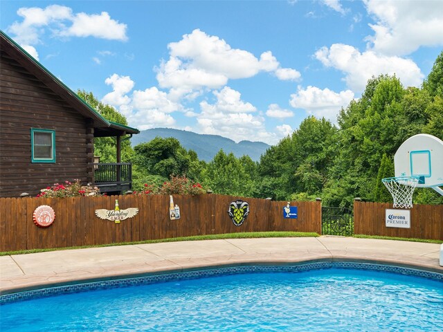 view of swimming pool with a mountain view