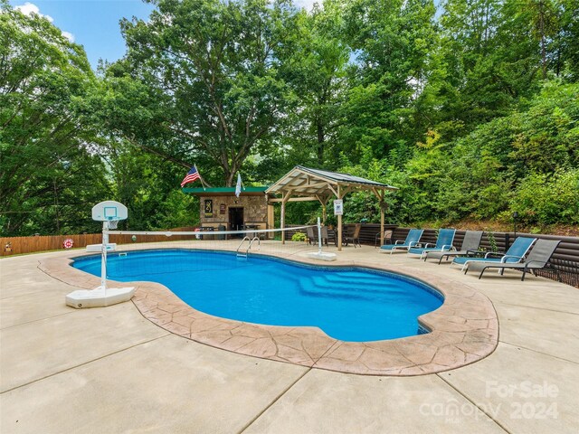 view of swimming pool with a patio and a gazebo