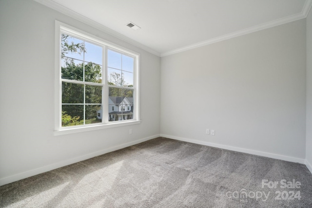 carpeted spare room with ornamental molding, visible vents, and baseboards