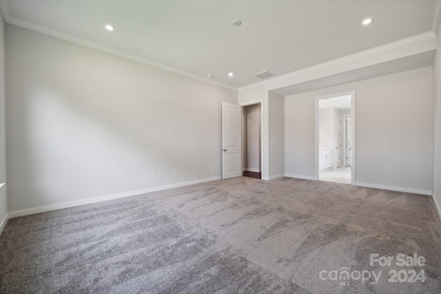 unfurnished room featuring light colored carpet and ornamental molding