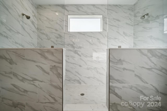 full bathroom with a marble finish shower