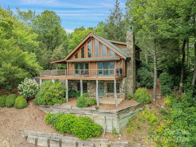 rear view of property with a balcony and a patio