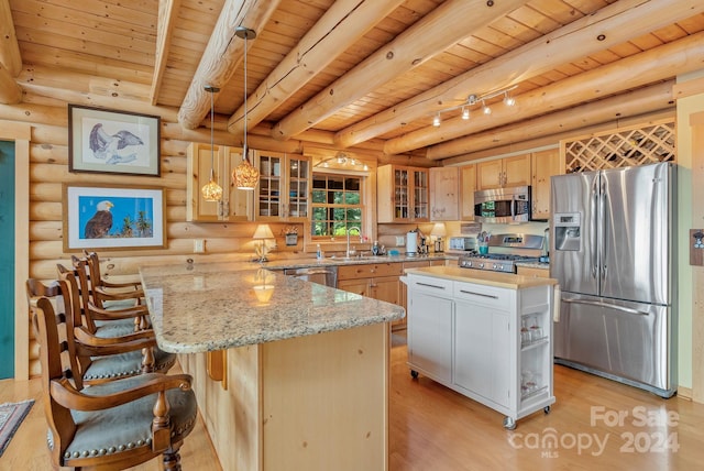 kitchen featuring pendant lighting, wood ceiling, rustic walls, a center island, and appliances with stainless steel finishes